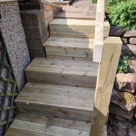 This customer required the existing concrete steps to be made wider and deeper. Making a frame and using deck boards managed to achieve customer request. Also Added hand rail for safety. : Click Here To View Larger Image